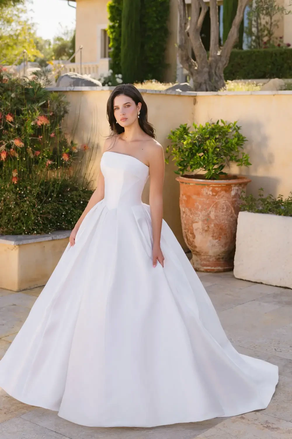 model is wearing a strapless ball gown