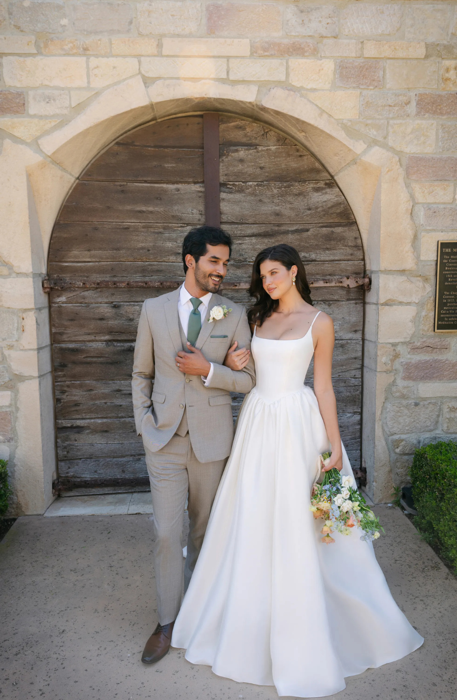 model is wearing a sleeveless square neck a-line wedding dress