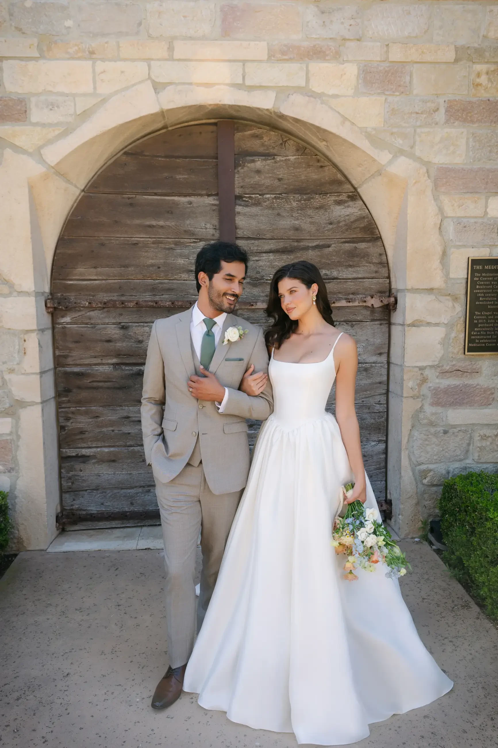 model is wearing a sleeveless a-line bridal gown