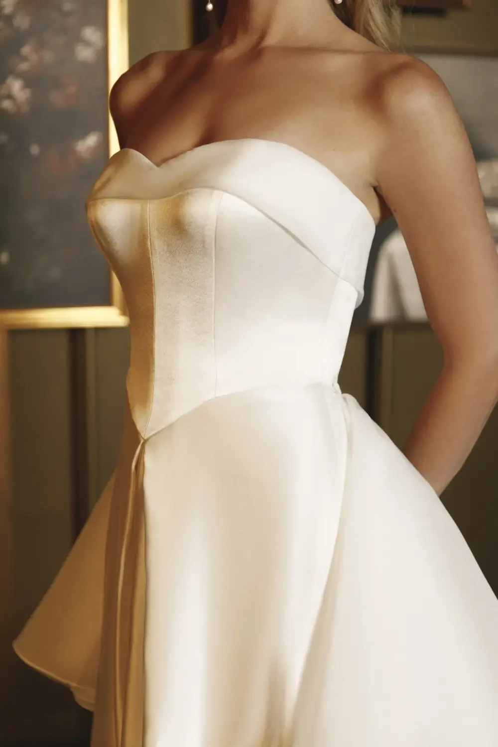 model is wearing a strapless satin bridal gown