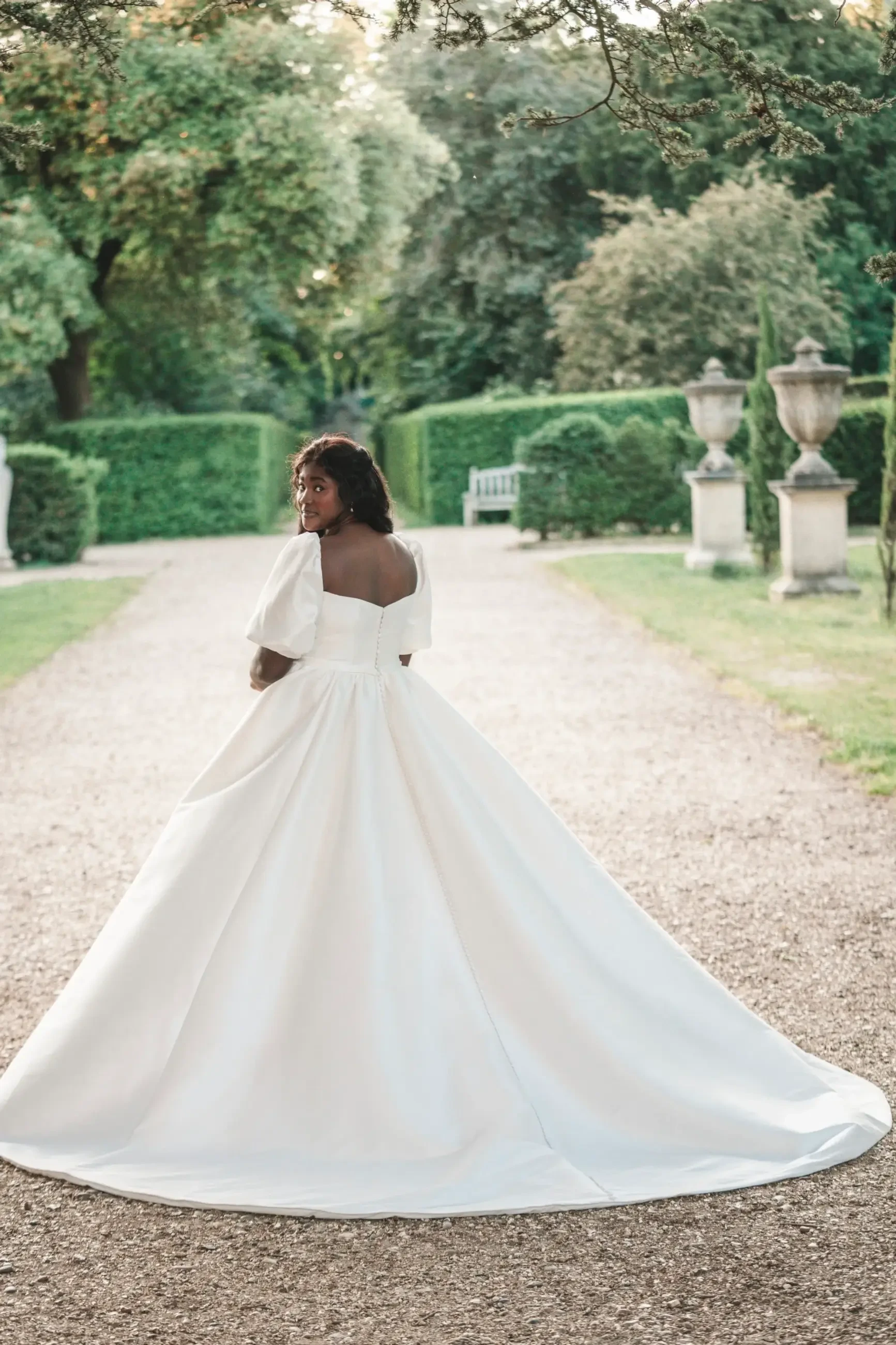 model is wearing a short sleeve a-line plus size wedding dress