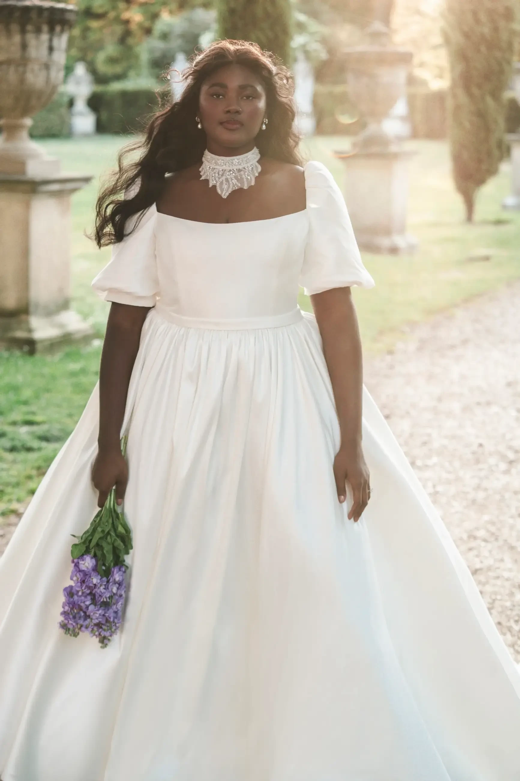 model is wearing a short sleeve a-line plus size wedding dress