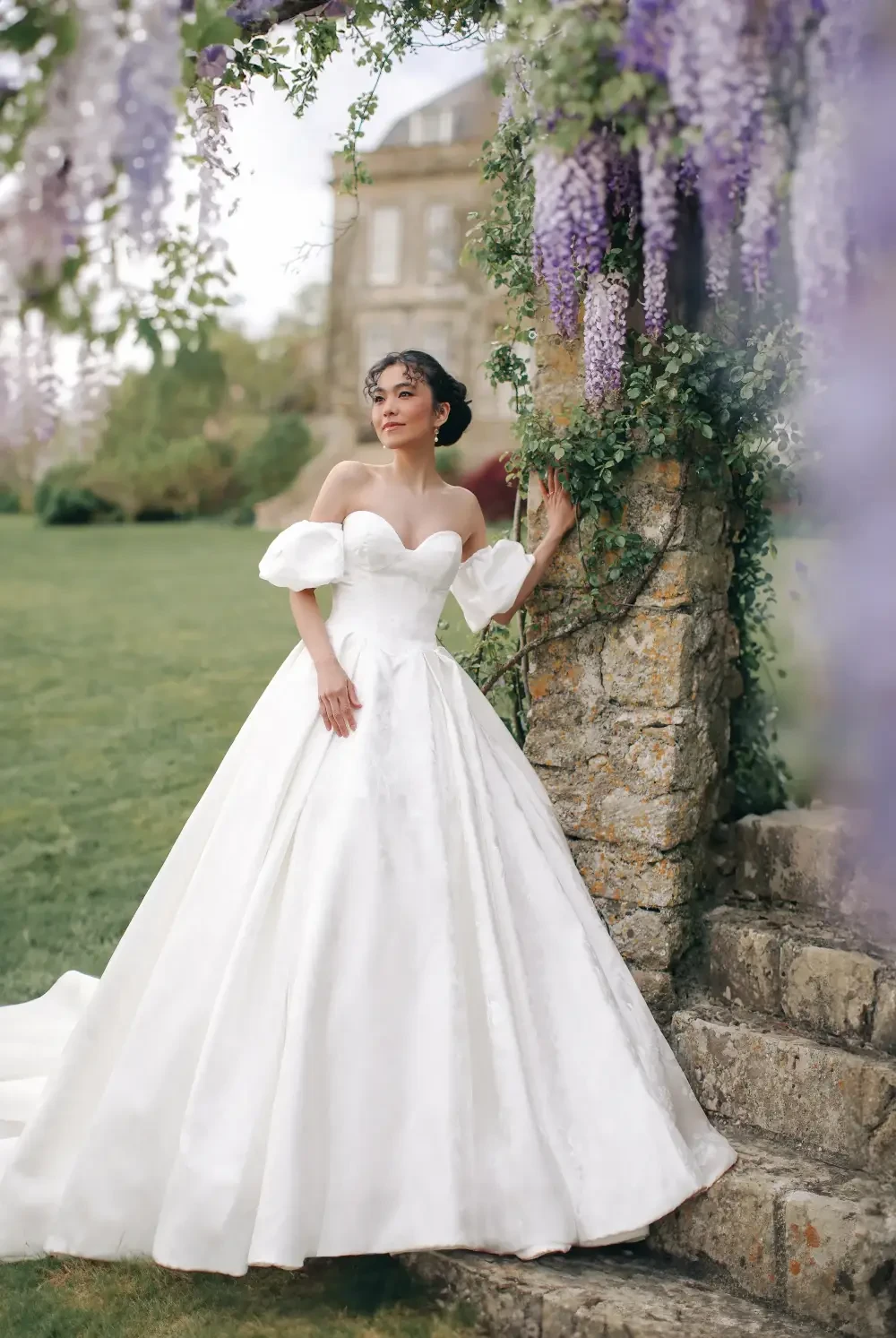 model is wearing an a-line wedding dress with short detachable puff sleeves