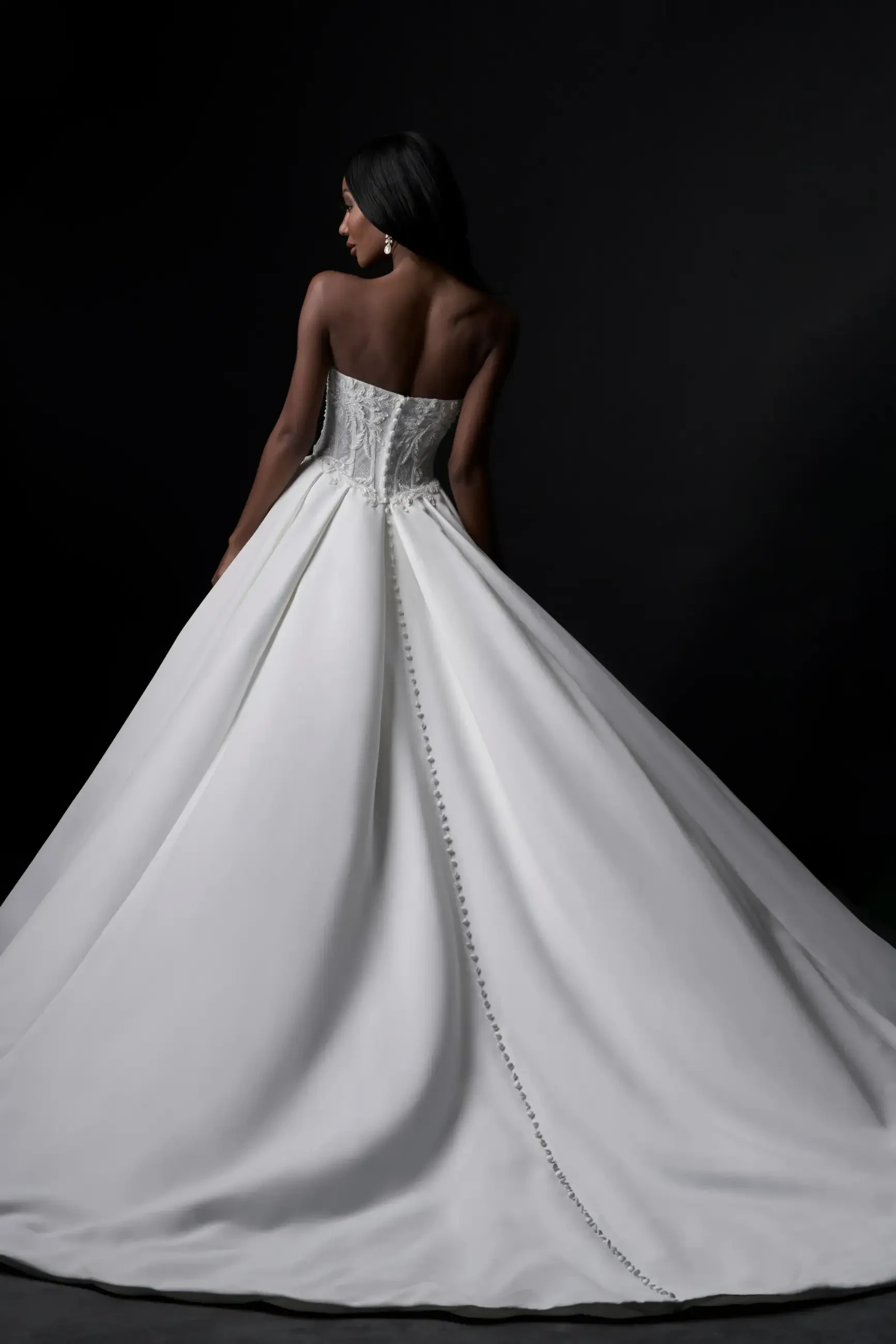 model is wearing a strapless ball gown wedding dress
