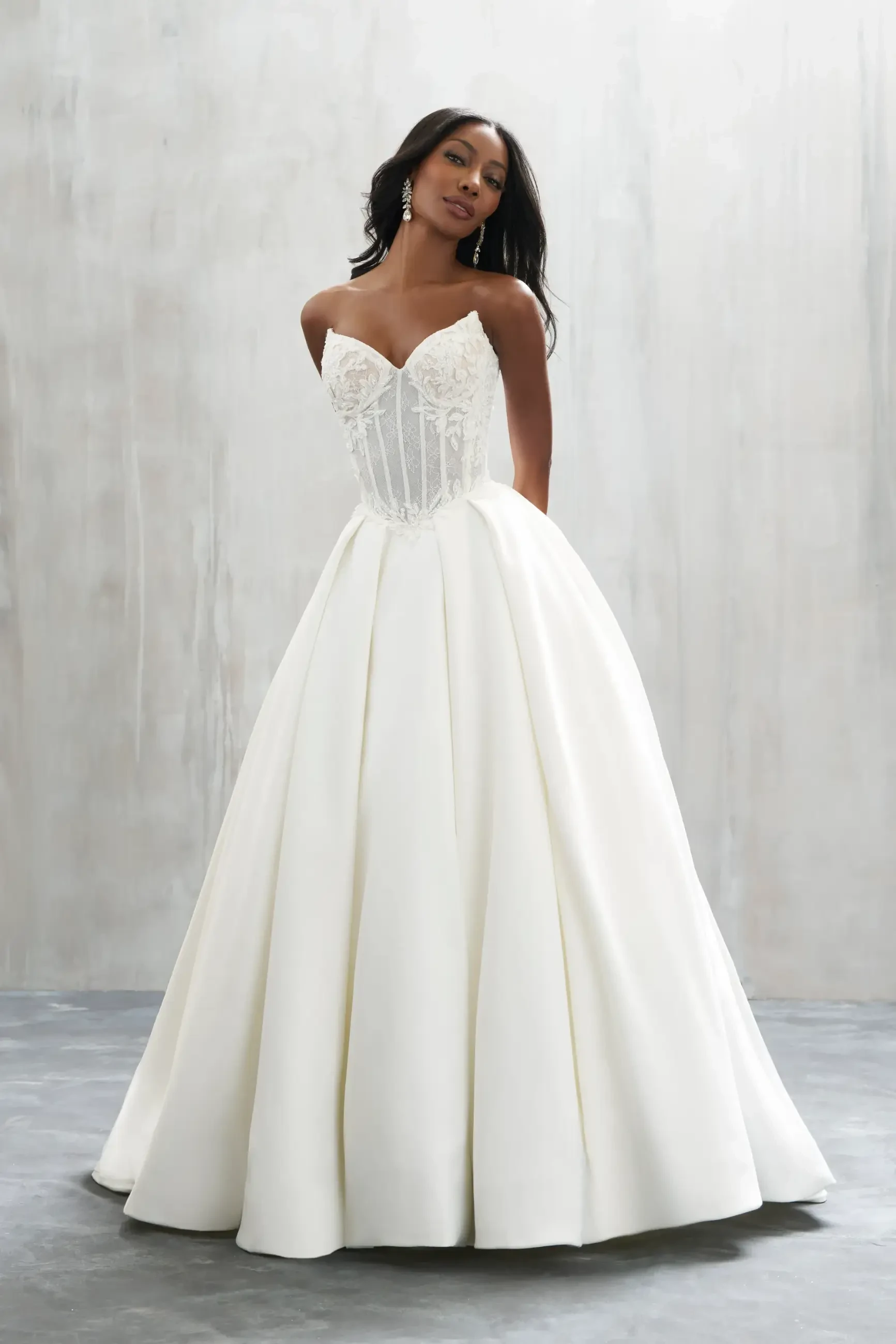 model is wearing a strapless ball gown wedding dress