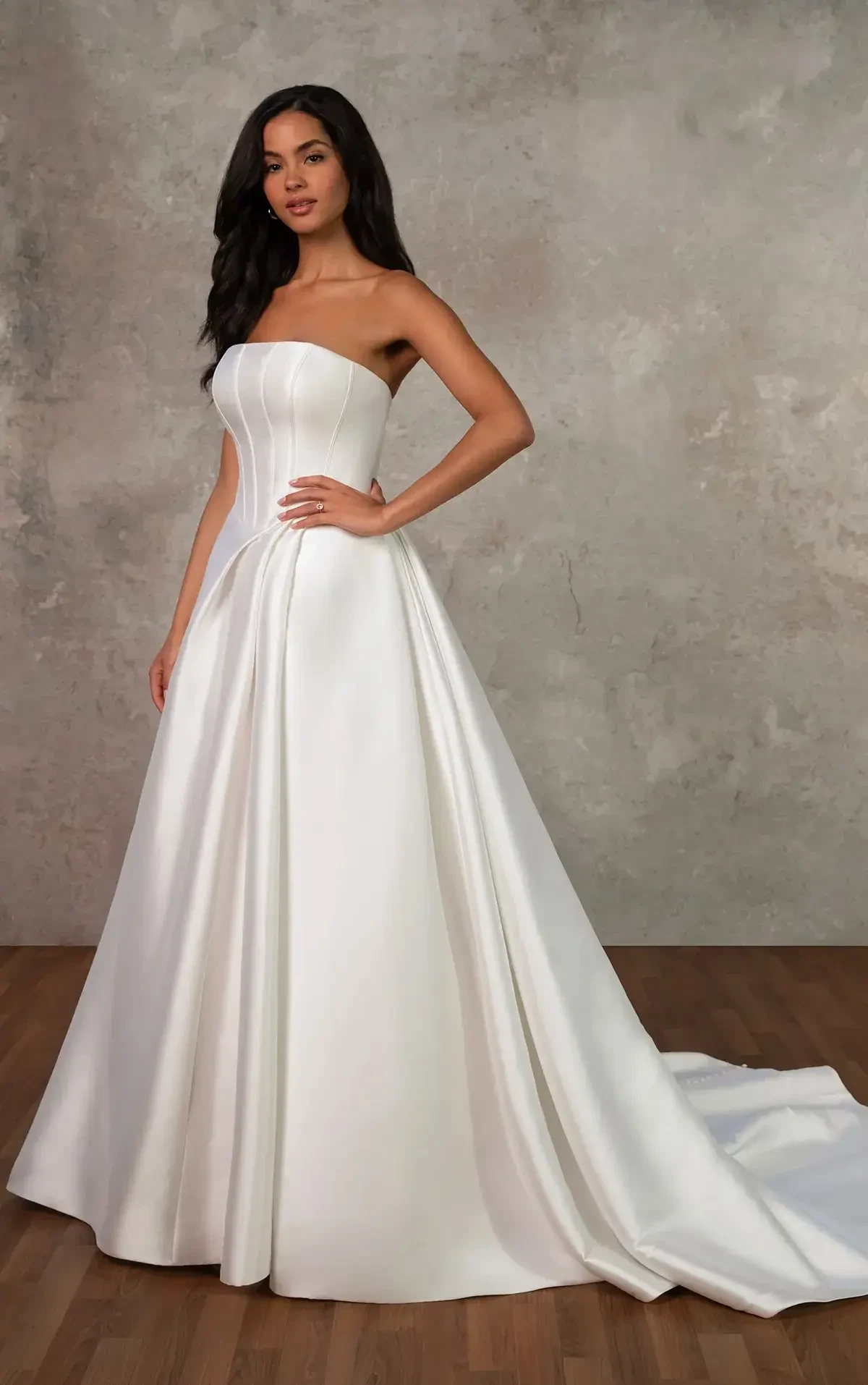 model is wearing a strapless ball gown wedding dress