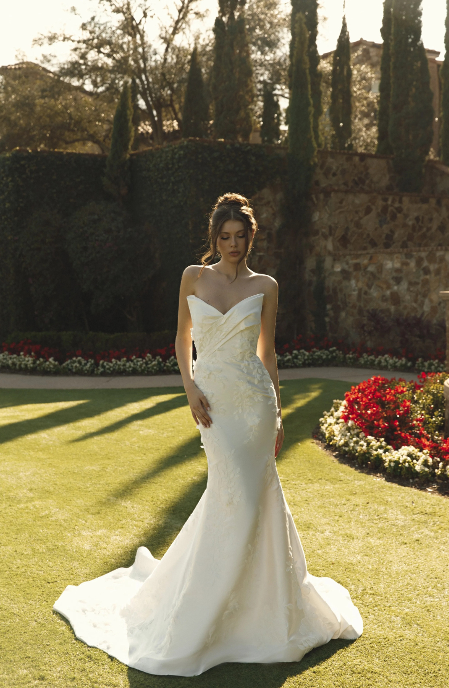 model is wearing a strapless fit and flare bridal gown