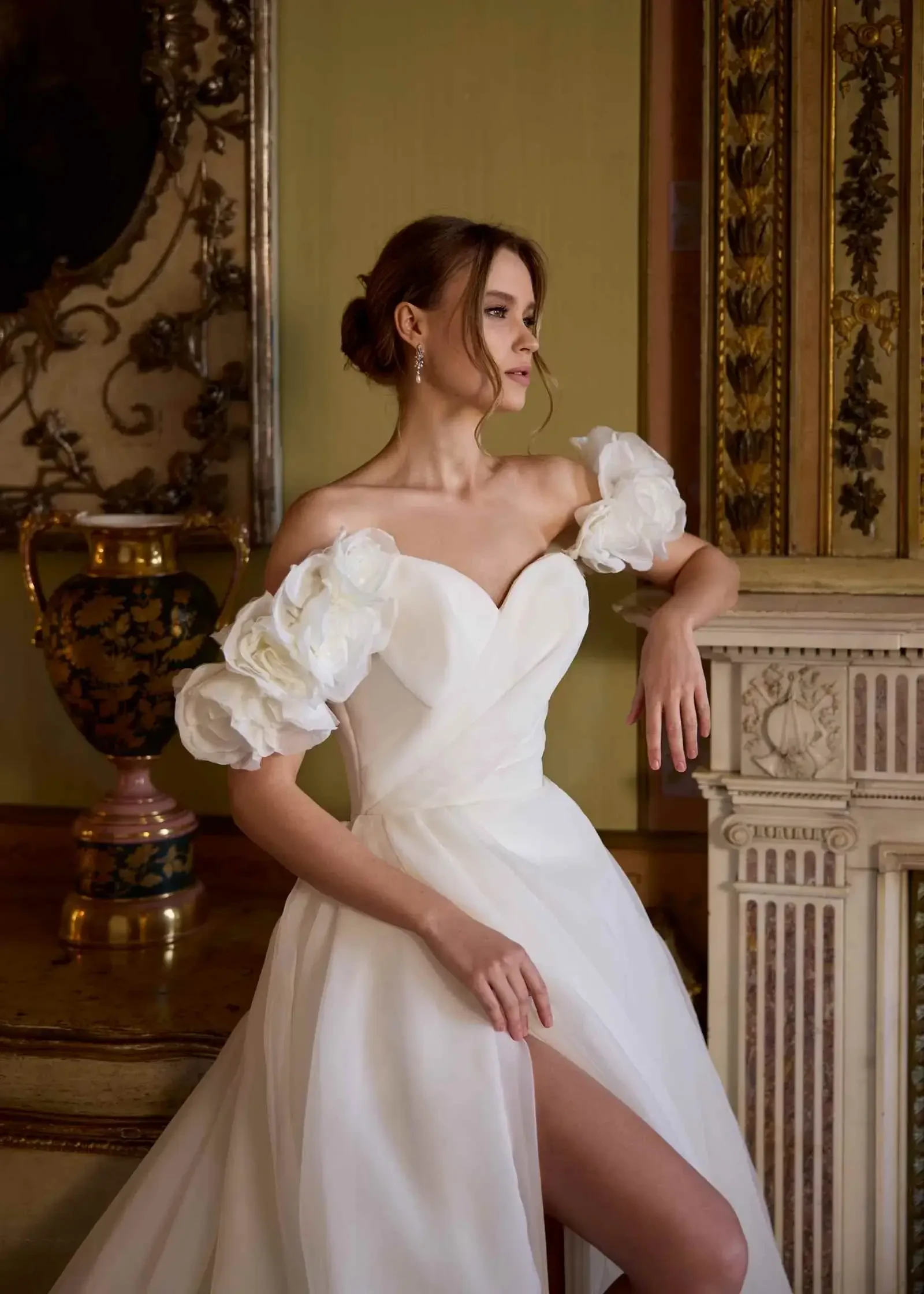 model is wearing a ball gown with puff sleeves