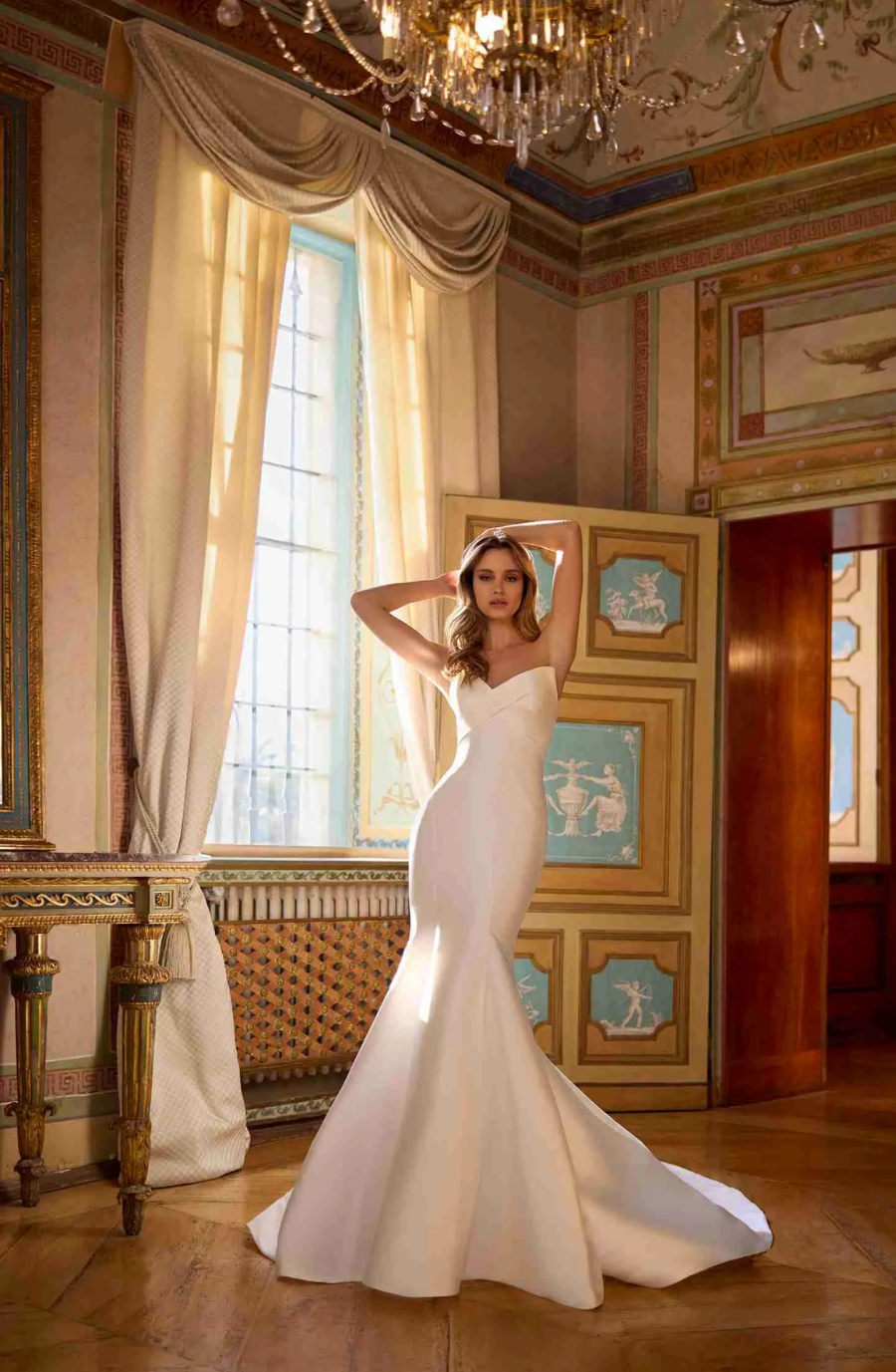 model is wearing a strapless mermaid bridal gown