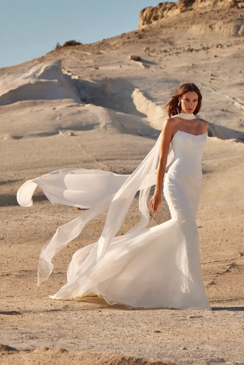 model is wearing a strapless bridal gown with a neck scarf