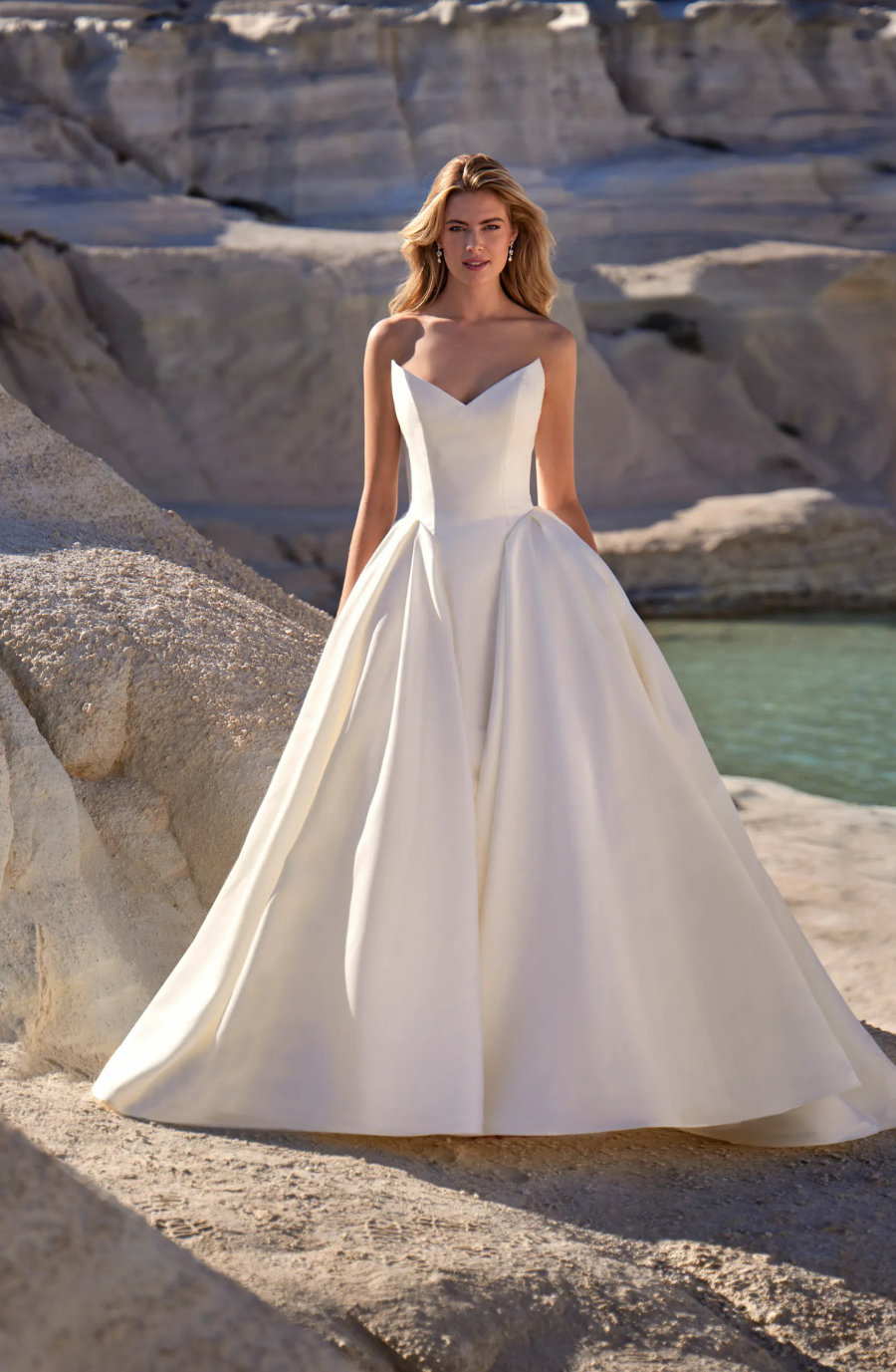 model is wearing a strapless ball gown wedding dress
