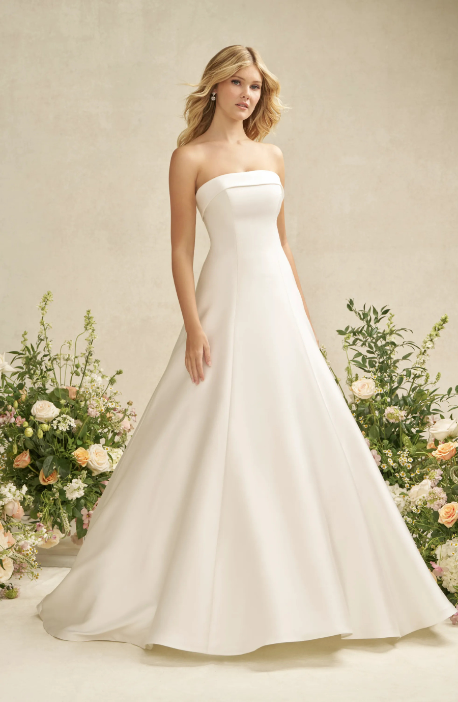 model is wearing a strapless a-line wedding dress