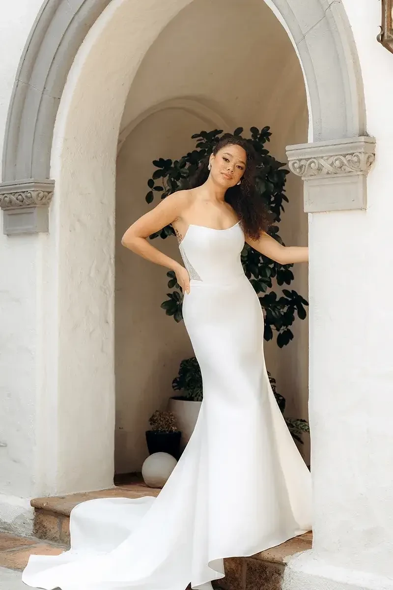 model is wearing a minimalist strapless bridal gown