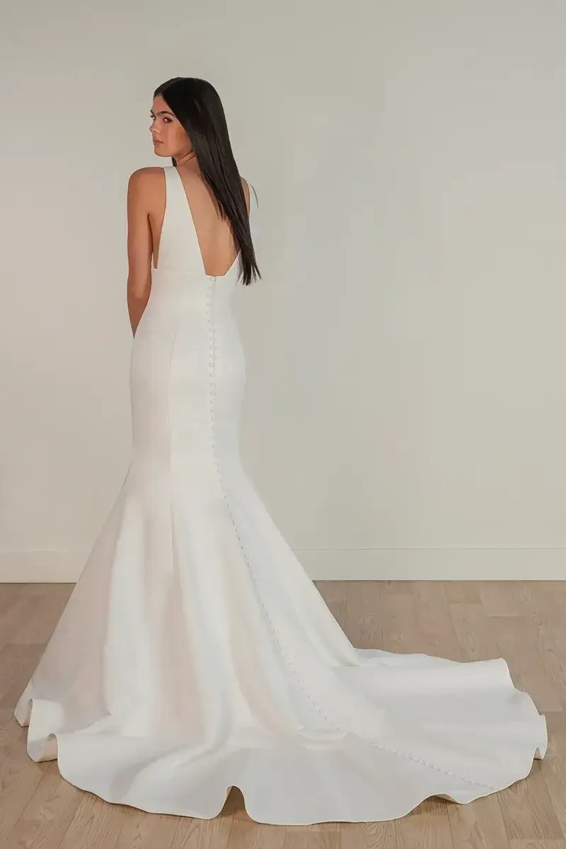model is wearing a sleeveless mermaid wedding dress