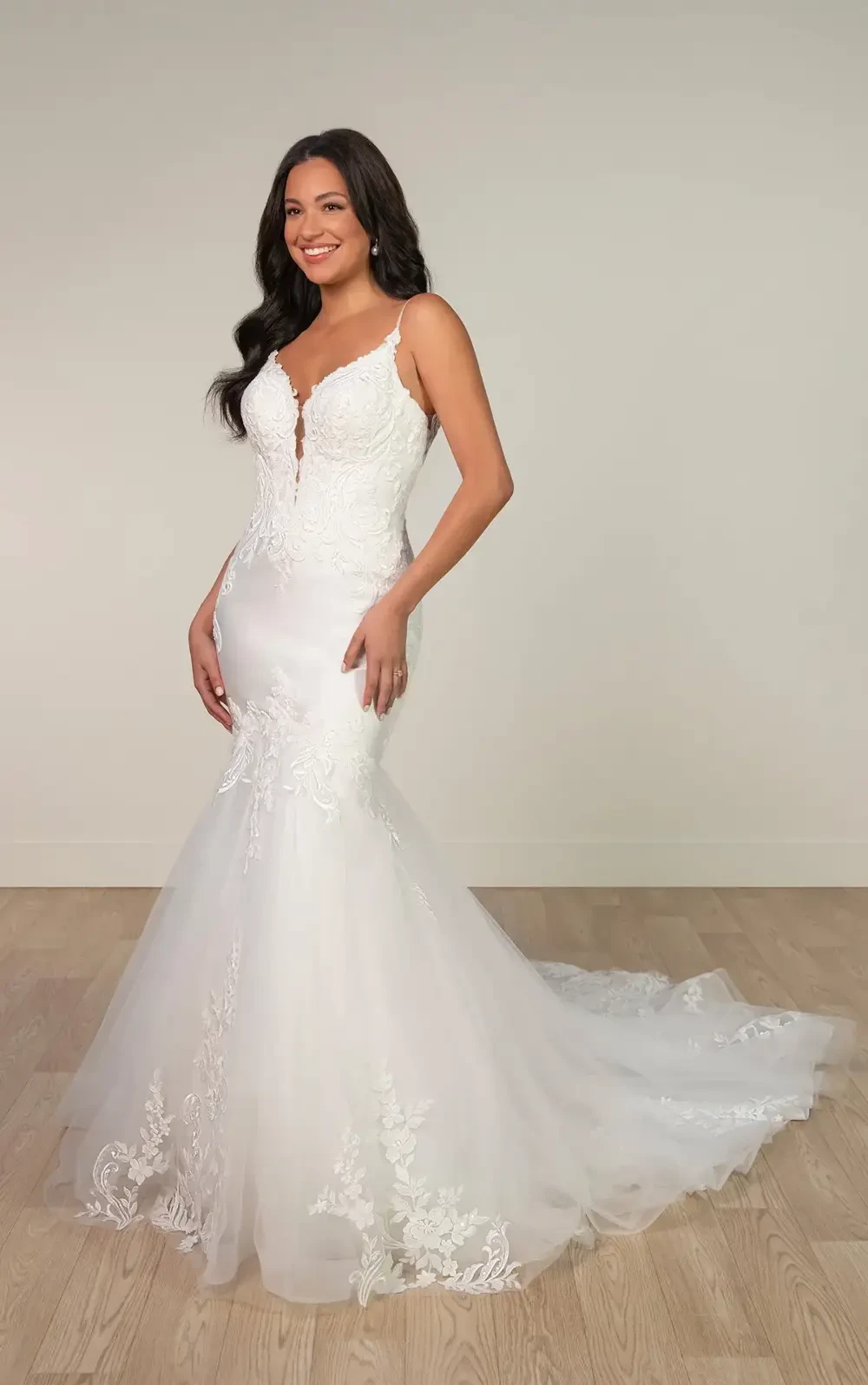 model is wearing a sleeveless lace fit and flare wedding dress