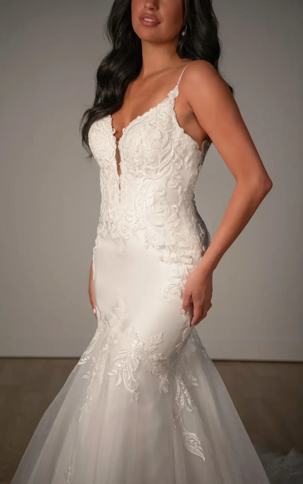 model is wearing a sleeveless lace fit and flare wedding dress