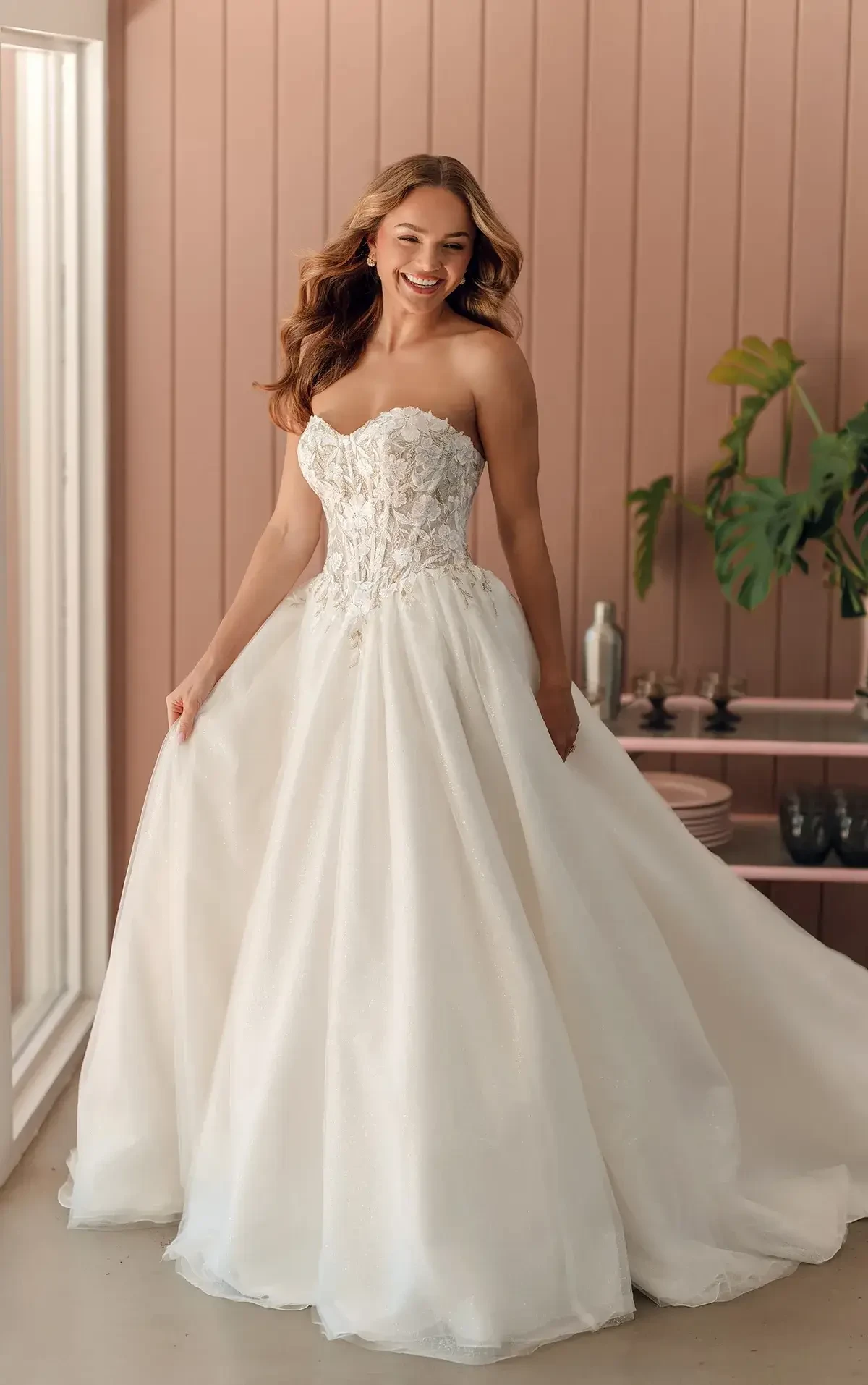 model is wearing a strapless ball gown